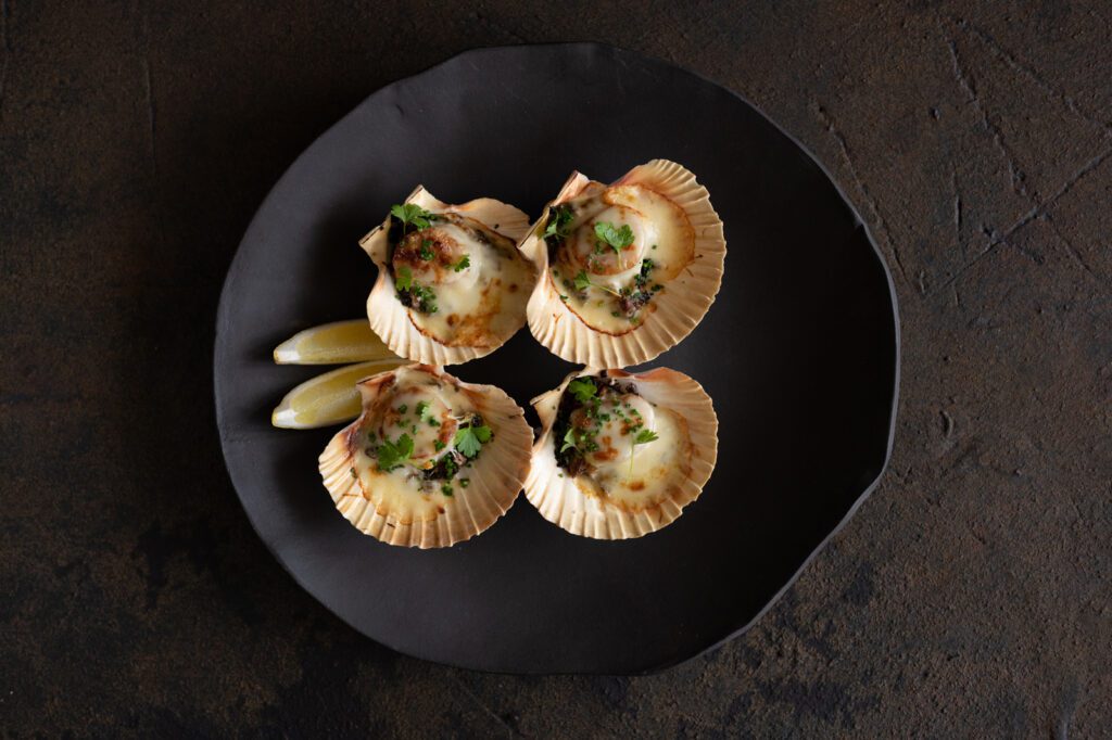 Vermouth poached Baked Scallops with mushroom duxelles and Gruyere cheese